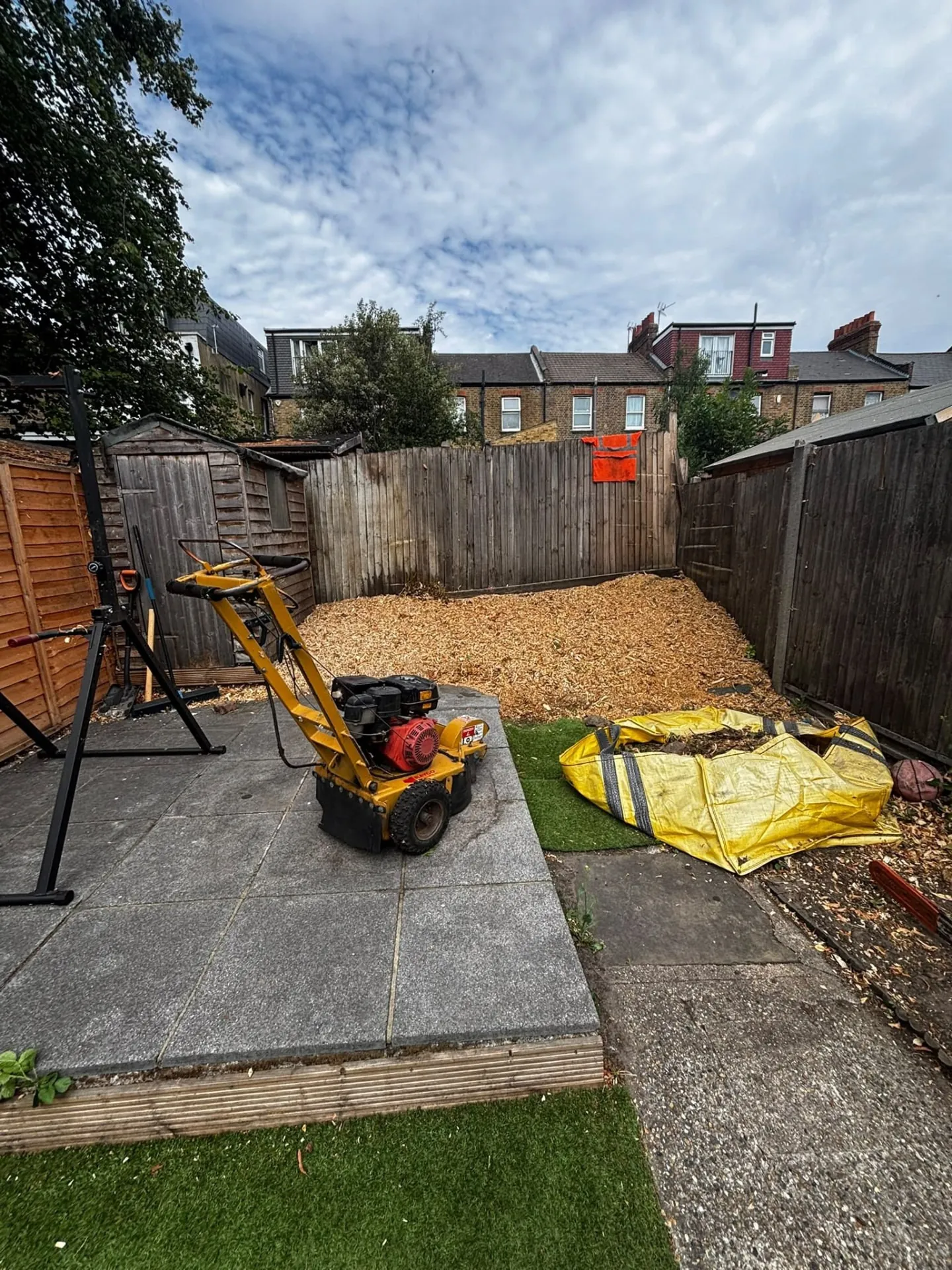 Stump grinder and wood chippings after stump removal in a garden