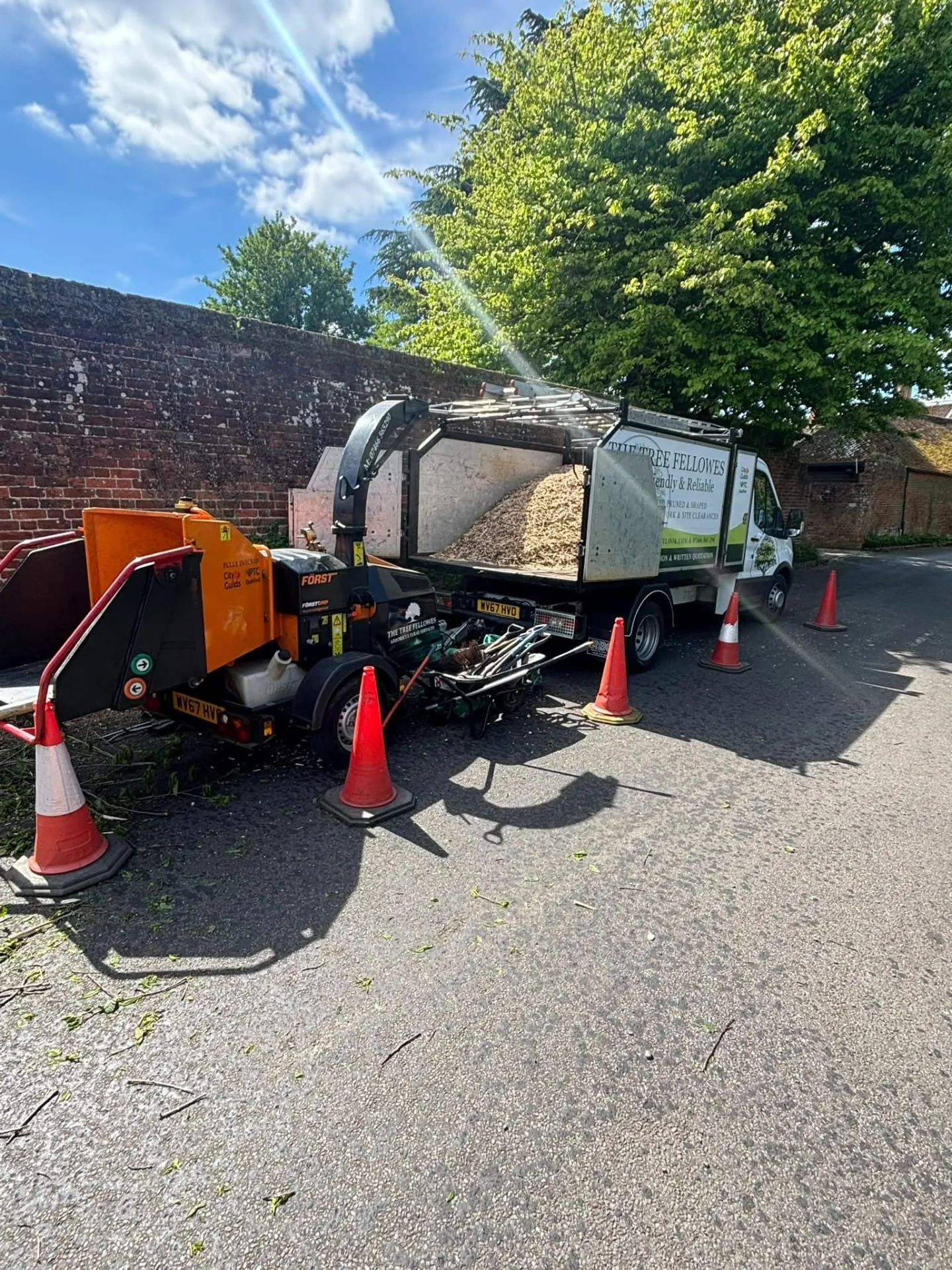 The Tree Fellowes truck and wood chipper set up safely with traffic cones
